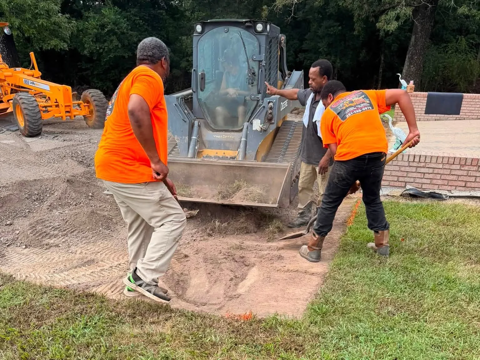 3M Paving and Excavation crew grading a driveway base with a LeeBoy motor grader and a track loader