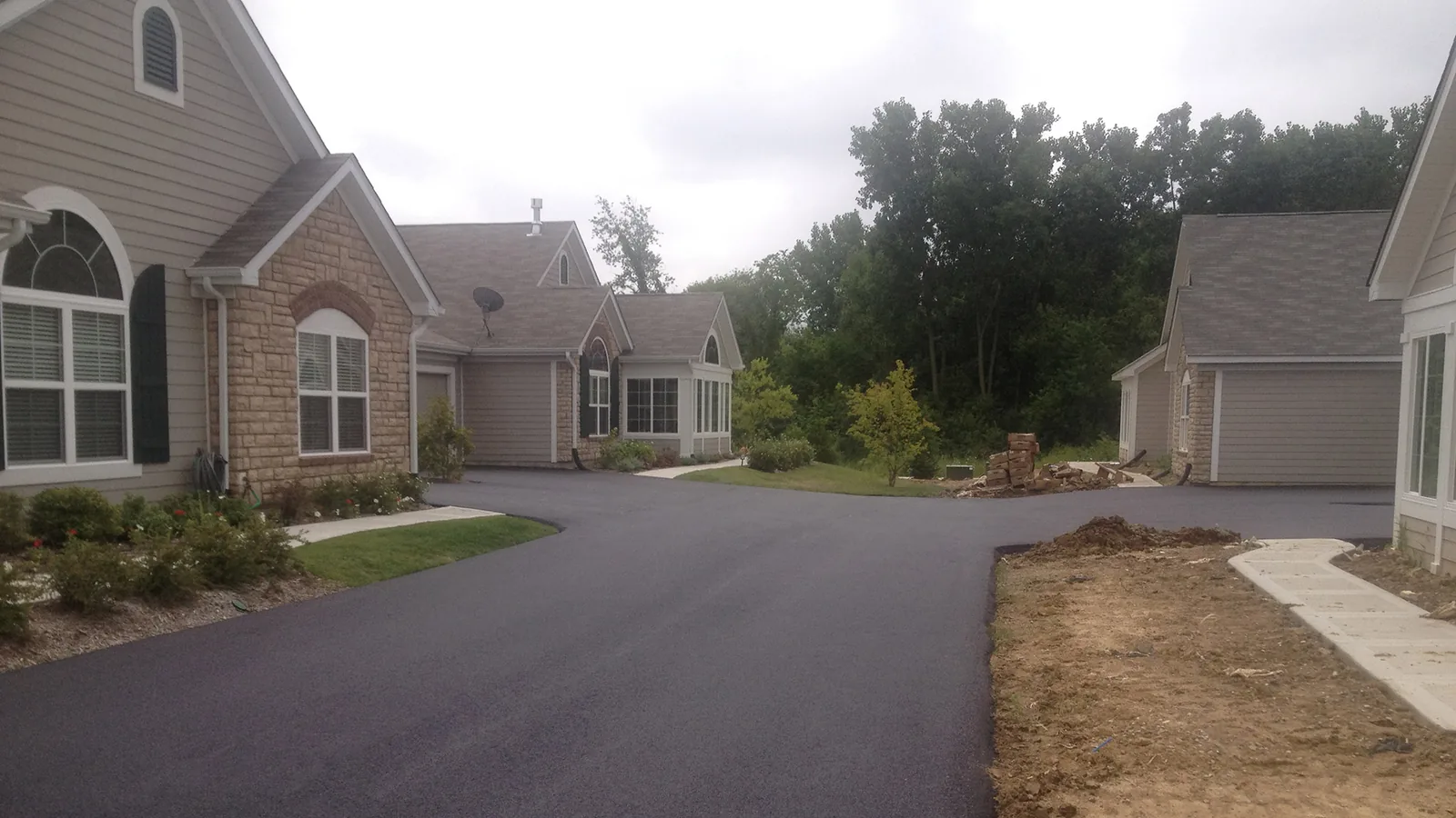 Newly paved street running between homes in a subdivision