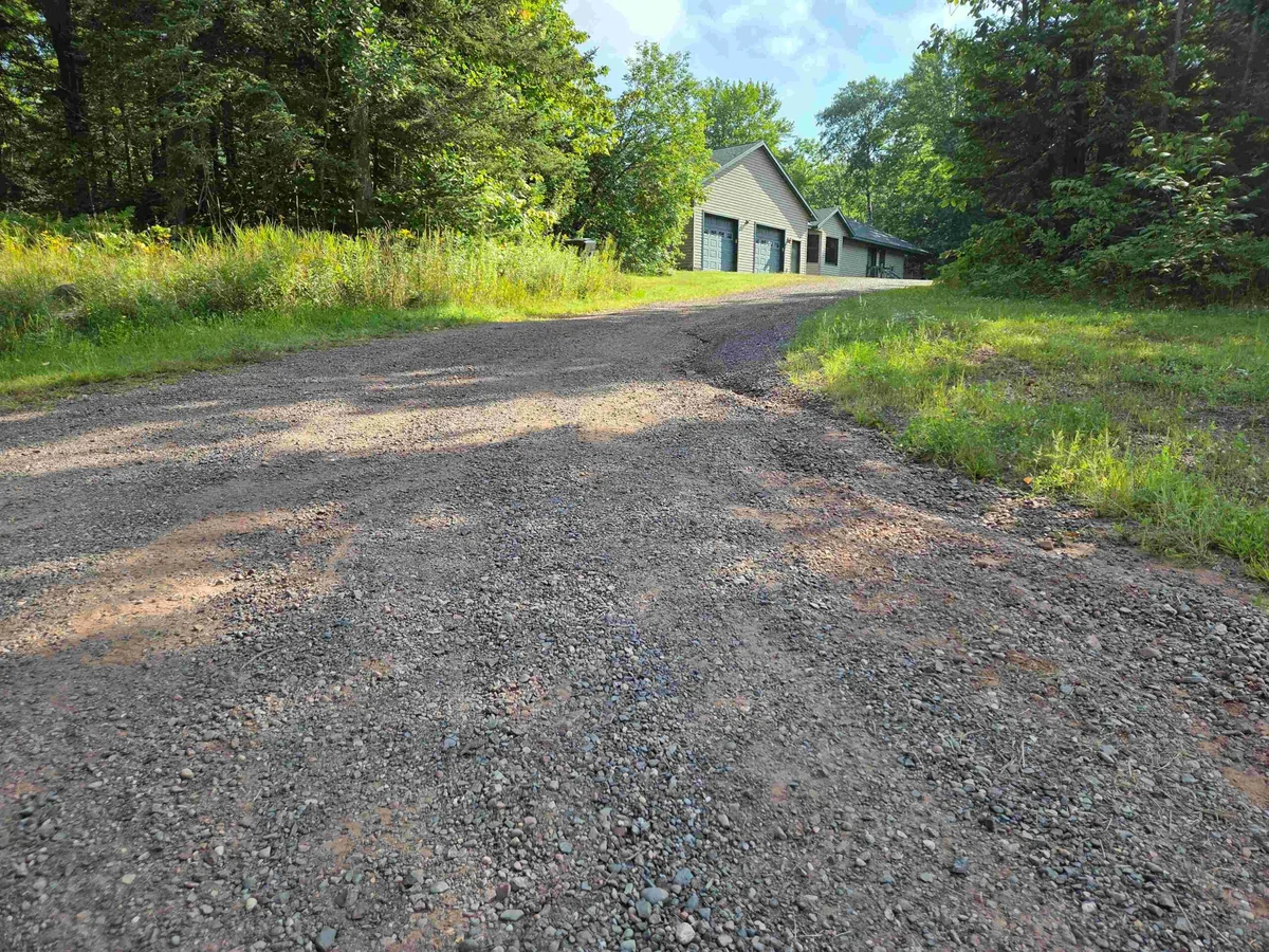 Crush and run gravel driveway running up to a detached garage