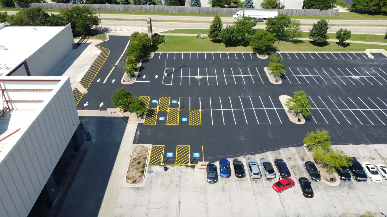 Aerial view of a freshly surfaced and striped parking lot with accessible spaces